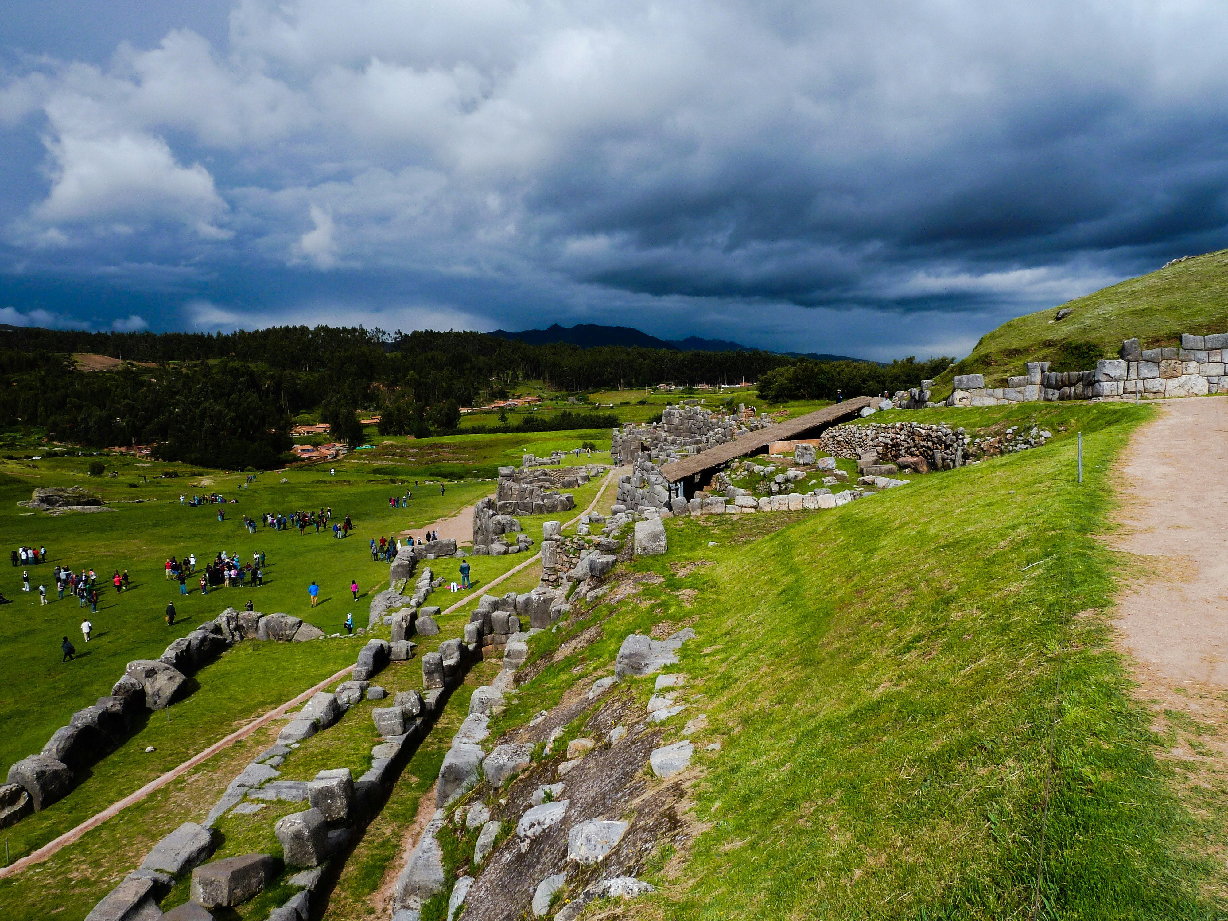 people standing near stone hedges